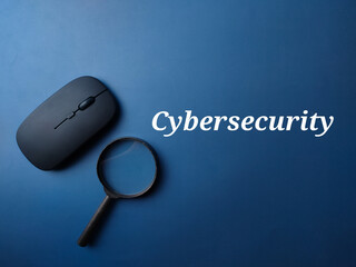 Black mouse and magnifying glass with word Cybersecurity on a blue background