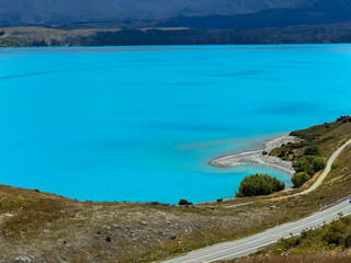 the bright blue water of lake tekapo in new zealand 