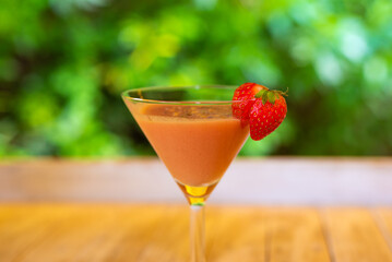 A delicious strawberry cocktail garnished with fresh strawberries.