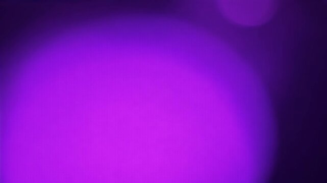 Shimmering purple light effects with soft bokeh particles set against a dark background creating a stunning animation element in 4K resolution