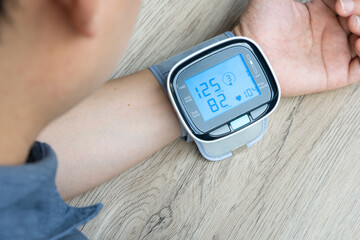Man check blood pressure monitor and heart rate monitor with digital pressure gauge. Health care...
