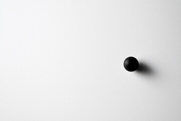 Minimalist black round object on a white background, emphasizing simplicity and modern design