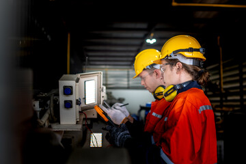 group of male engineer workers maintenance automatic robotic arm machine in a dark room factory....