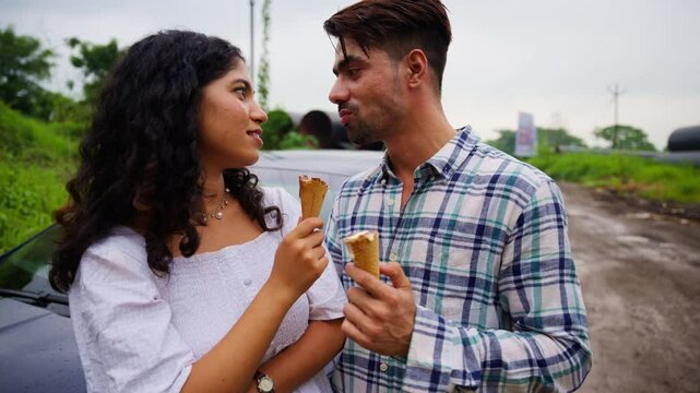Lover share ice cream passionately with each playful bite