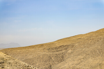 Mountains and blue sky with passing clouds.