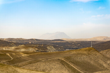 Mountains and blue sky with passing clouds.