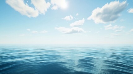 Fototapeta premium Vast open ocean view under a sunny clear sky with soft clouds and calm waters
