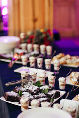 Dessert buffet with individual brownies and trifles