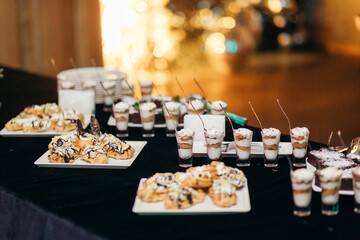 Dessert buffet with trifles and eclairs at a New Year or Christmas party