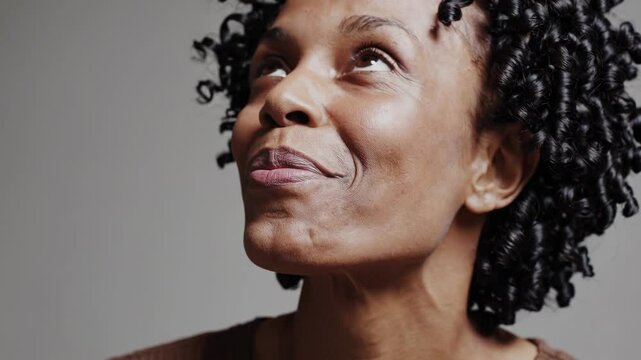 A series of close-up shots of different faces expressing happiness, surprise, or inspiration against a neutral background.
