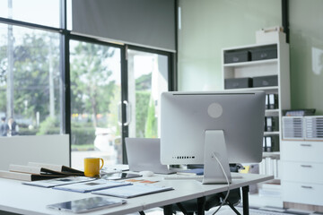 An office desk with a computer, documents, and graphs represents a workspace for professionals analyzing data, managing reports,making strategic decisions in business, finance, or administration