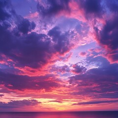 Obraz premium Vibrant sky with purple and pink clouds over a calm sea at sunset with golden light