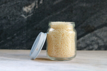 Rice in a glass jar on a white table