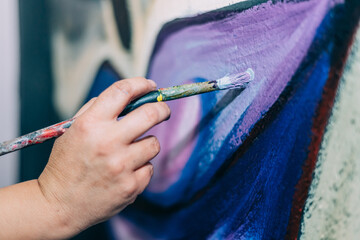 Female Artist Works on Painting,  Paint Brush, Creates Modern Masterpiece. Creative Studio. Close-up