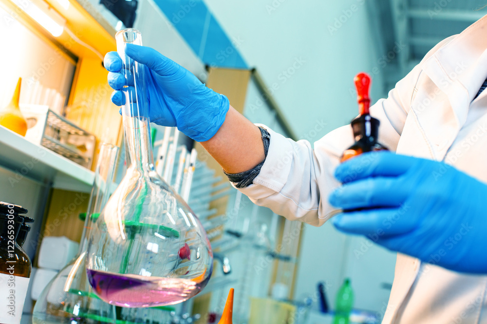 Poster researcher conducts chemical experiment with flask and reagent in laboratory setting