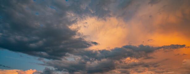 Sunrise sky background. Dramatic scenery sunset. Sky with clouds in Sunrise sky light background. Sunrise with clouds in various shapes. Calm Sunrise sky and sun through clouds over.