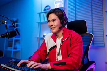 Asian young esport male gamer playing online video game on computer.  © Kawee