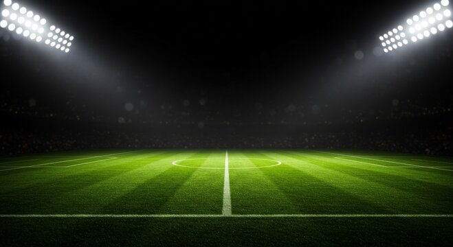 Soccer field illuminated by stadium lights with copy space on dark background 