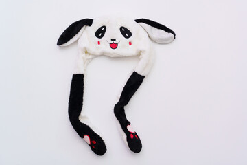 Funny children's hat with ears and muzzle on a white background. Fun children's clothing and accessories.