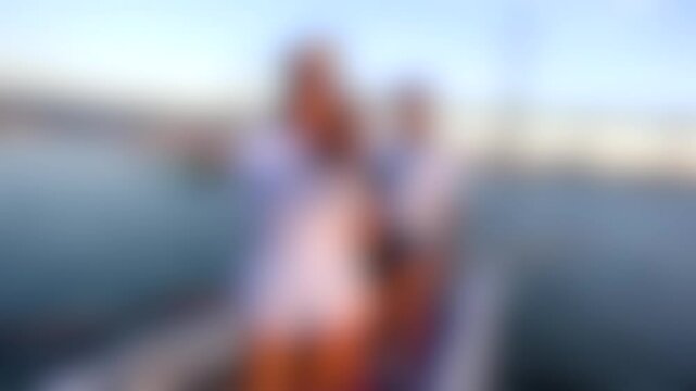 Blurred scene of two people on a boat against a serene water backdrop, capturing leisure, travel, and relaxation moments, ideal for creative lifestyle visuals.