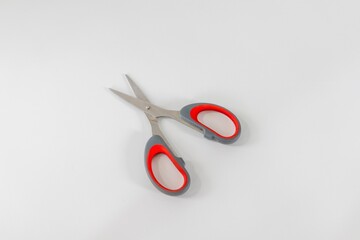 An open pair of scissors on a white background
