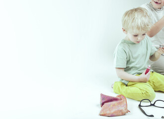 Two children playing makeup artist with cosmetic products