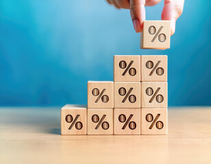 Hand-picked wooden blocks with percentage symbols and up arrows. Interest rates and dividends. Returns on stocks and mutual funds. Long-term investing for retirement