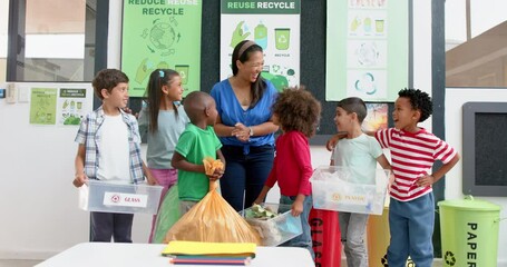 Sorting recyclables into bins, teacher and children in school learning about recycling - Powered by Adobe