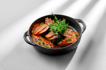 A vibrant and flavorful roasted eggplant dish, topped with fresh herbs and a drizzle of balsamic glaze. The eggplant is tender and juicy, and the sauce is rich and flavorful.