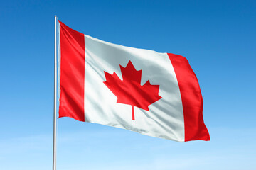 Waving canada flag, national symbol, blue sky