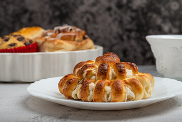 Close-up of a freshly baked stuffed bun on a white plate