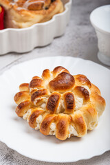 Close-up of a freshly baked stuffed bun on a white plate