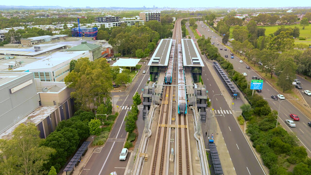 Aerial drone view of a train departing from Rouse Hill station on the metro North West railway line, Greater Sydney, NSW Australia in January 2025 