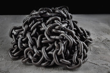 Iron chain piled up on concrete