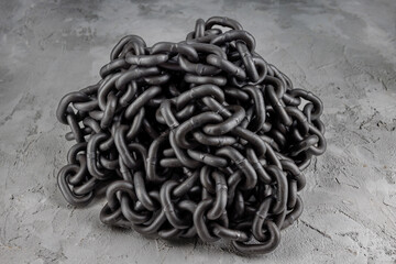 Iron chain piled up on concrete
