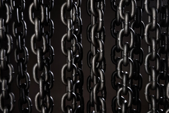 Heavy iron chain. background of iron chains hanging in even rows on a gray background.