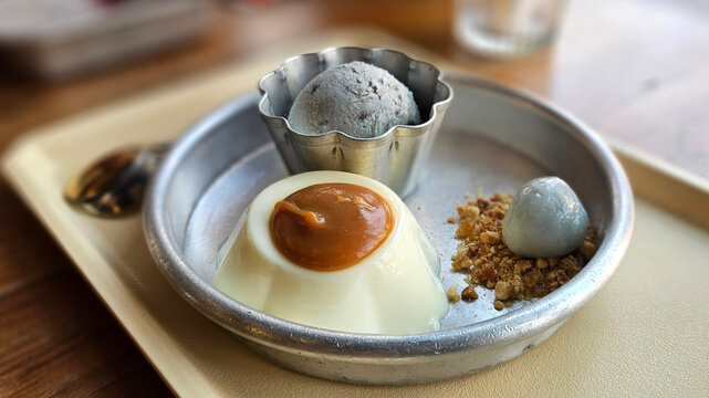 Black sesame homemade ice cream scoop serving with Chinese style glutinous rice balls, and caramel eggs pudding