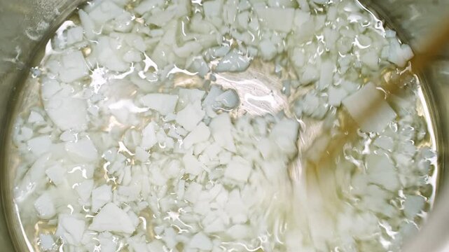 close-up. Soy Wax Flakes Melt In A Saucepan for candle making.
