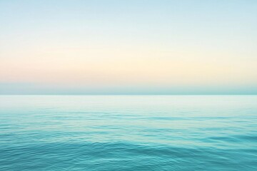 Obraz premium Serene ocean view at dawn with gentle waves reflecting soft pastel colors of the sky