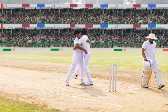 Bowler celebrates with captain after he had taken the wicket