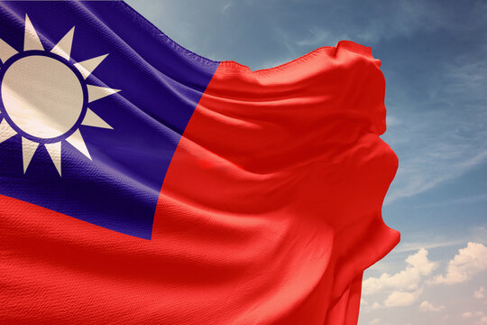 Waving flag of Taiwan in blue sky. Taiwan flag on pole for Independence Day. The symbol of the state on wavy fabric.