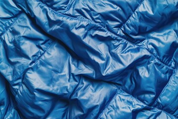 A close-up of a blue sleeping bag with a zipper and straps, great for outdoor or camping scenes