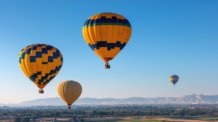 Obraz premium Hot air balloons soar over a desert landscape at sunrise. Travel, tourism, adventure