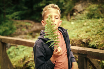 Wild child holding wild fern