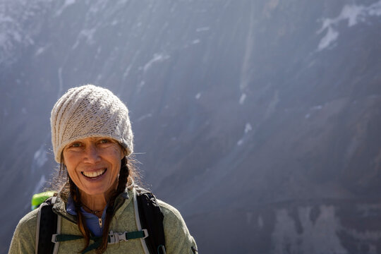 Female wears cold weather gear while trekking Nepal
