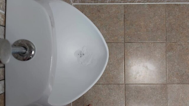 Wall-mounted men's urinal in a public toilet. The concept of cleanliness and hygiene in public toilets. Copy space for text, enuresis