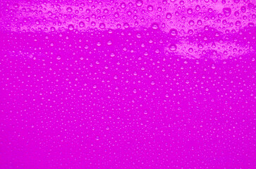 Detailed View of Droplets Resting on Maroon Background