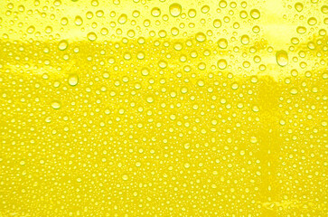 Detailed View of Droplets Resting on Yellow Background