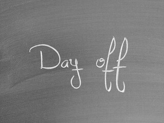 Day off text written on a chalkboard in stylish script