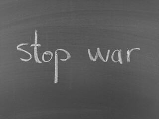 Obraz premium Stop war written on a chalkboard emphasizing peace and anti-war messages